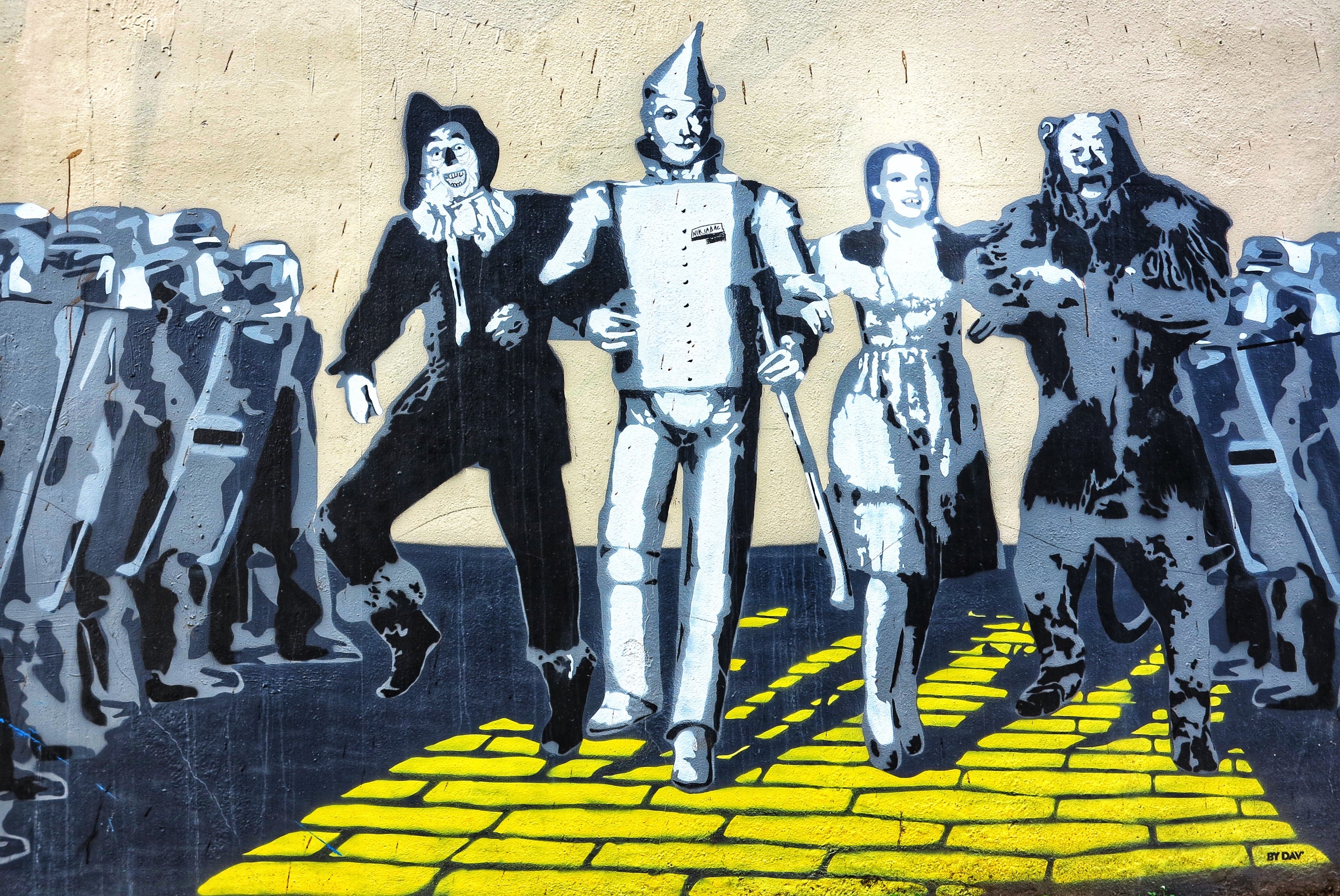 Wizard of Oz characters marching along the yellow brick path.